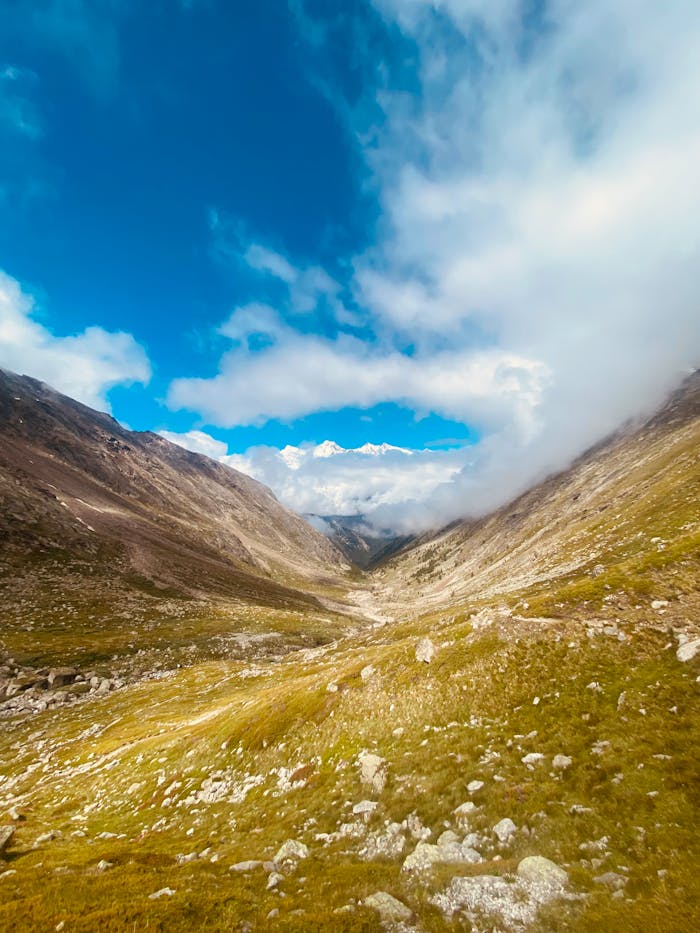 Scenic view of a stunning alpine valley surrounded by clouds in Saas-Almagell, Switzerland.